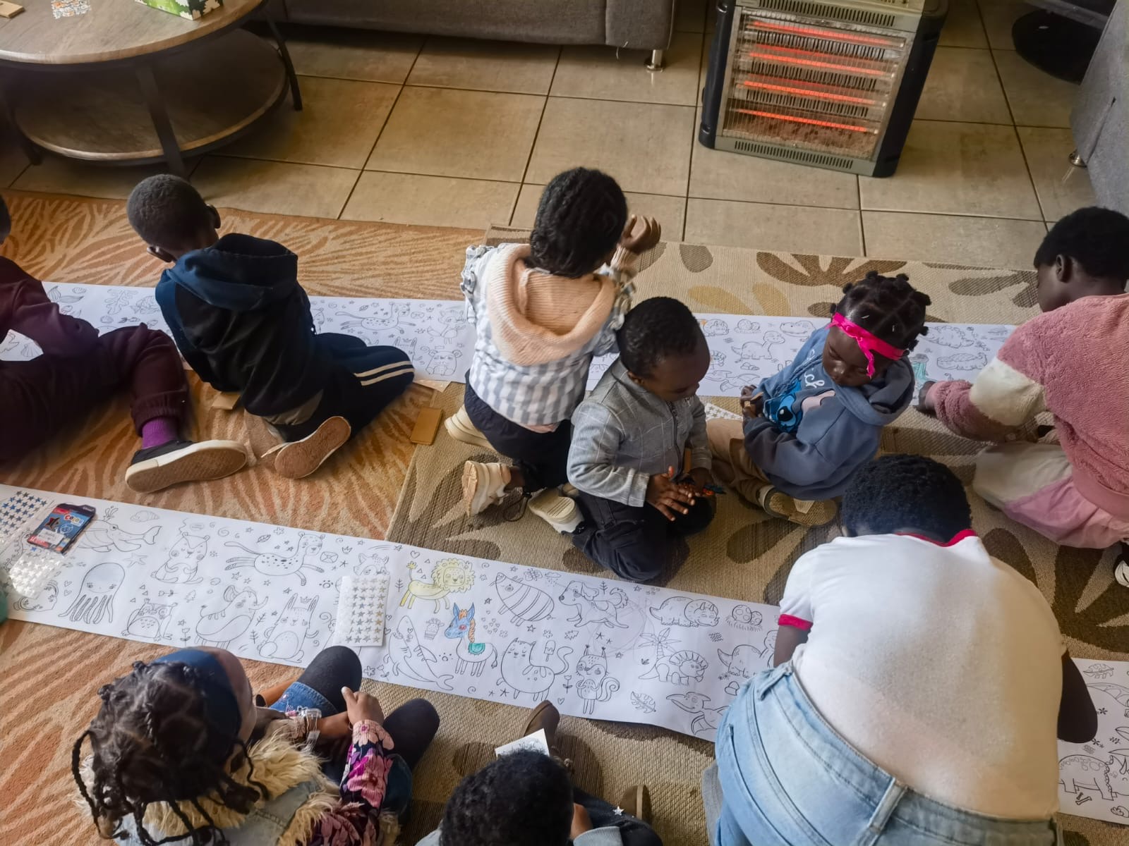 Children colouring and playing side by side